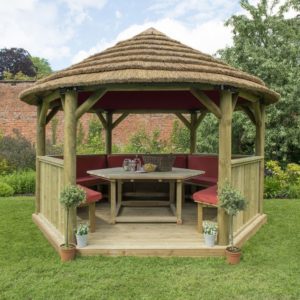 Forest Garden 4m Hexagonal Wooden Garden Gazebo with Thatched Roof - Furnished with Table, Benches and Cushions (Terracotta)
